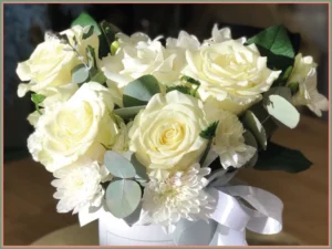 Bukiet białych róż w eleganckim pudełku.